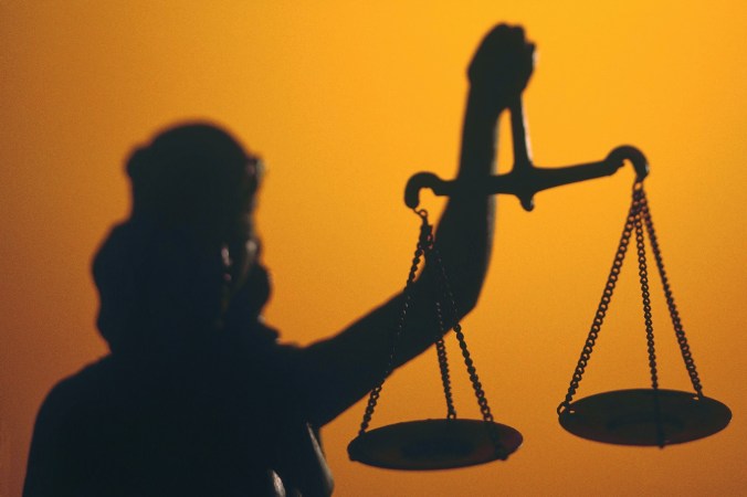 Silhouette of scales of Lady Justice holding scales